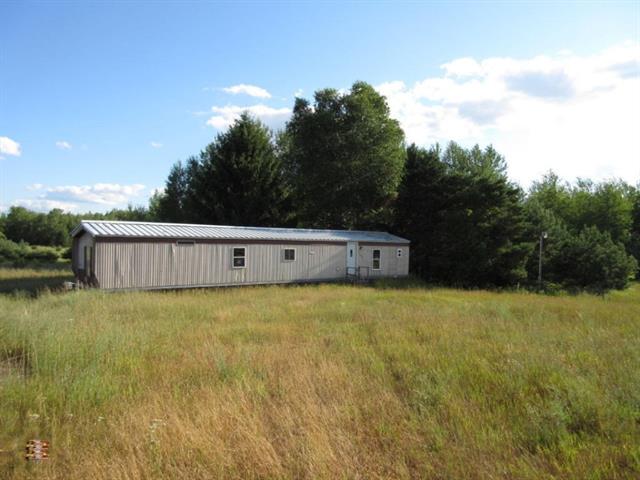 front view picture of 1595 W North County Line Road, Six Lakes, MI. 48886