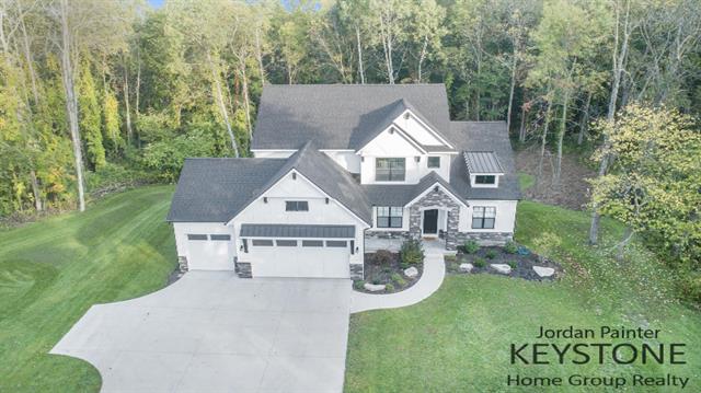 front view picture of 305 Honey Creek Avenue Se, Ada, MI. 49301