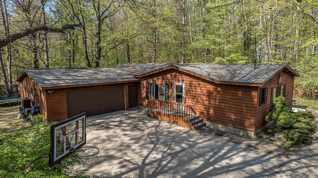 front view picture of 6313 Somerset Lane, Cadillac, MI. 49601