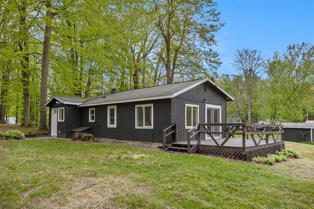 front view picture of 442 E Woodland Drive, Six Lakes, MI. 48886