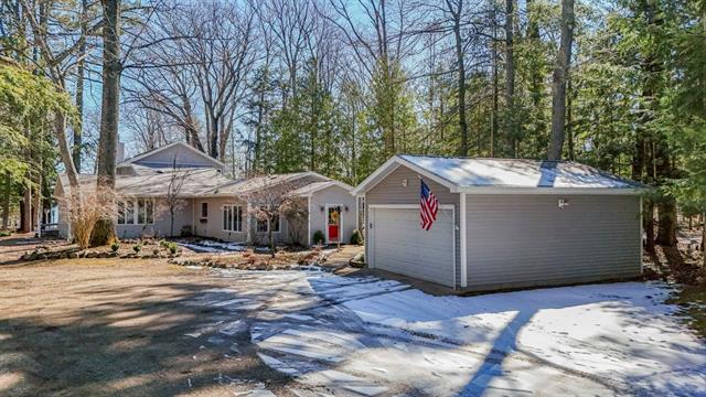 front view picture of 8666 Skegemog Point Road, Williamsburg, MI. 49690