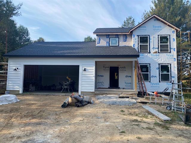 front view picture of 10402 Western Road, Rapid City, MI. 49676