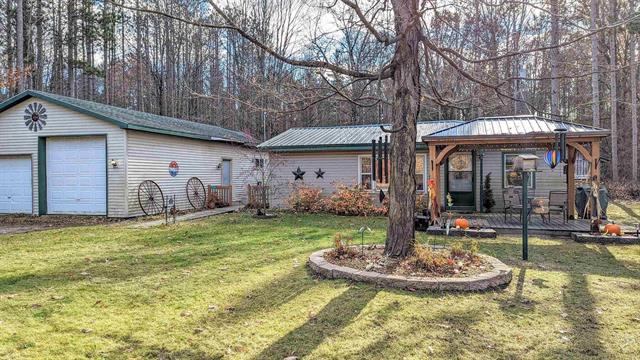 front view picture of 11631 N Hodenpyle Dam Road, Mesick, MI. 49668