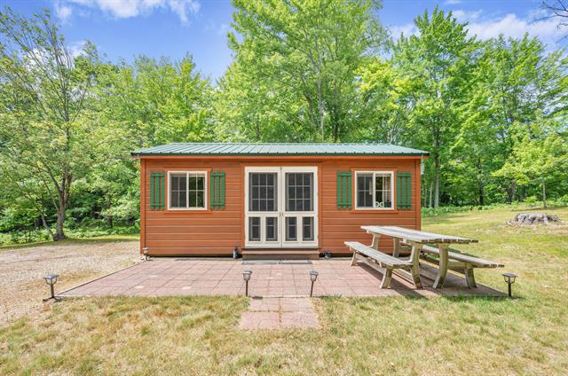 front view picture of 122 Canyon Rd, Leroy, MI. 49655