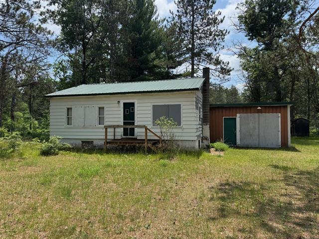 front view picture of 4231 W 5 Mile Road, Irons, MI. 49644