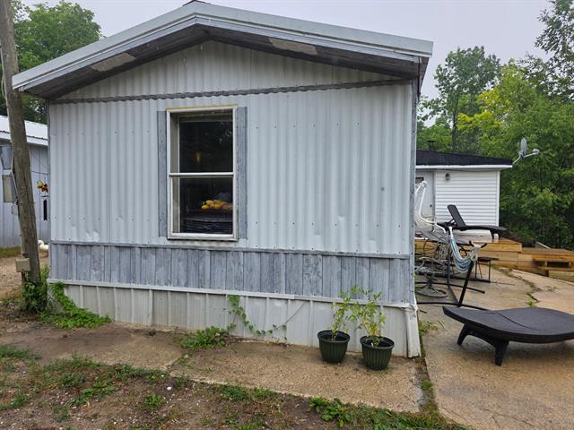 front view picture of 13063 17 Mile Road, Rodney, MI. 49342