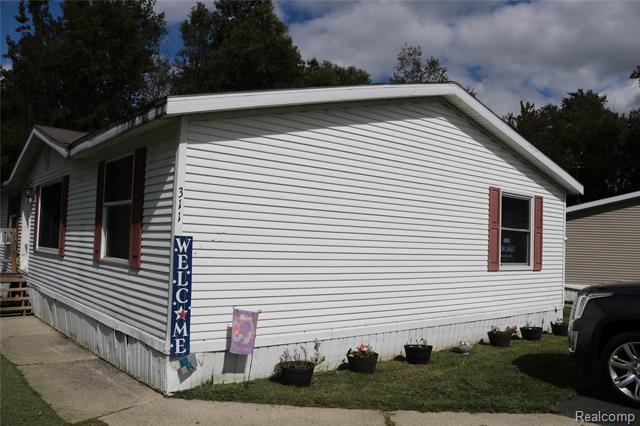 front view picture of 311 Peach Blossom Ct, Otisville, MI. 48463