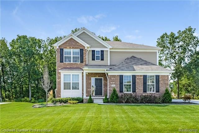 front view picture of 57797 Village Dr, New Hudson, MI. 48165